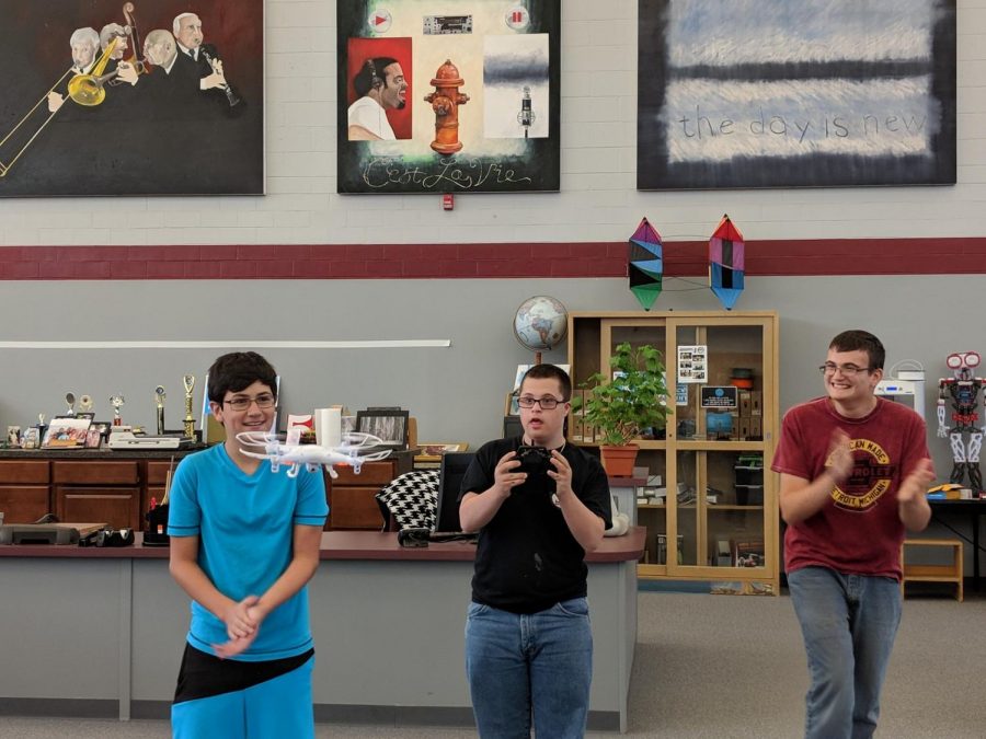 Ryan+Tomaino+cheers+on+Rotator+students+as+they+work+a+drone+in+the+media+center.+